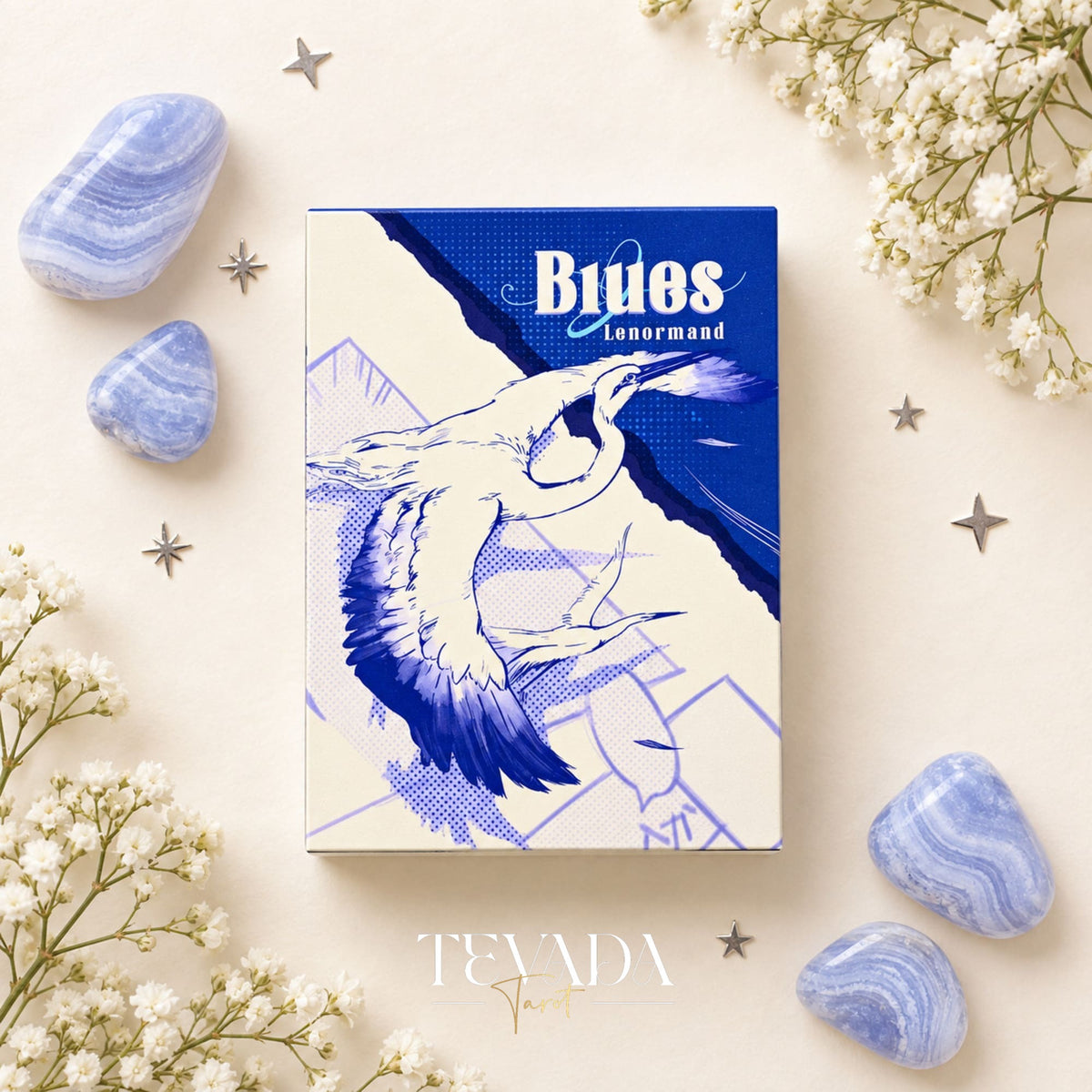 Blue Lenormand cards with star-pattern backs and symbolic illustrations, including a bear, arranged among blue stones and white flowers.