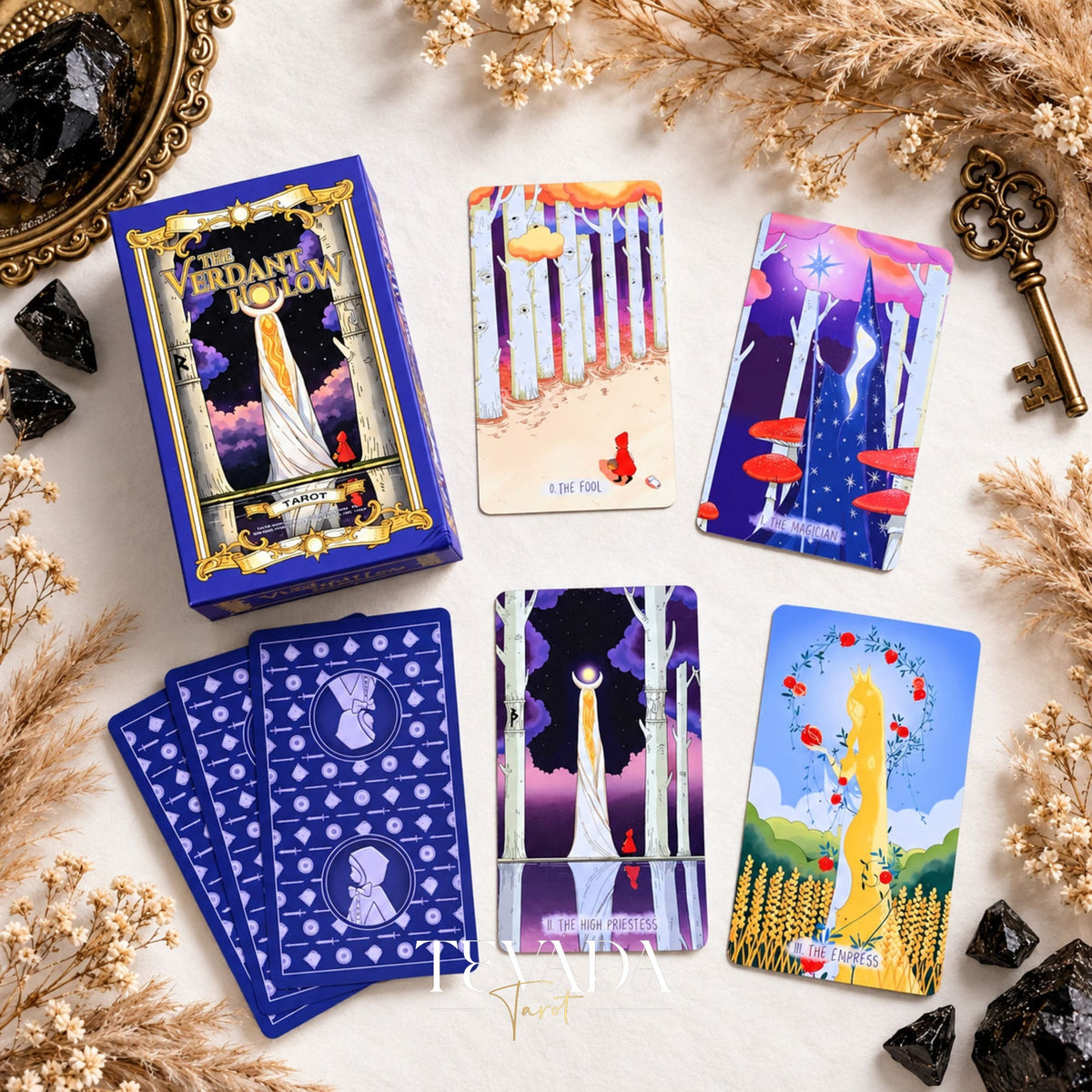 The Verdant Hollow Tarot box, card backs, and colorful Major Arcana cards displayed together