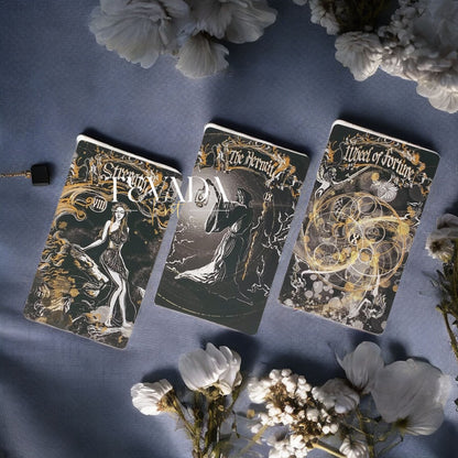 Unlock wisdom through the Dark Ray Tarot DELUXE, a 78-card deck in bold black, white, and gold tones designed for intuitive readings, clarity, and spiritual growth.