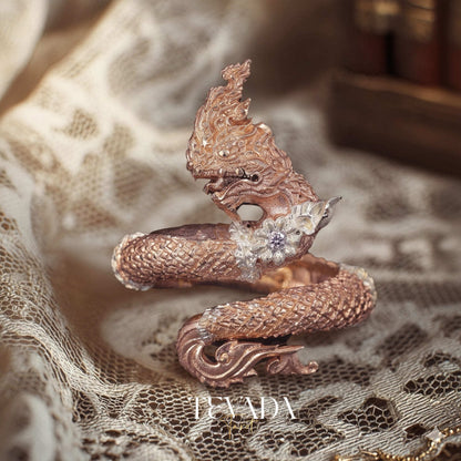 Discover the Naga Devine Dragon Charm Ring, a blend of Thai spirituality and elegance. Imbued with good luck and fortune, this 24K gold-plated amulet is a symbol of protection and prosperity. Embrace mystical charm!