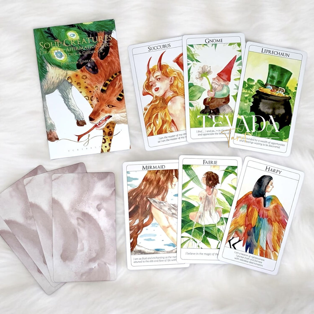 Unleash your intuition with the Soul Creatures Tarot + Oracle Duo Set. A 78-card tarot deck and 48-card oracle, each hand-painted with mythical creatures to guide your personal growth and transformation.