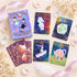 Alice’s Illusory Dream Lenormand REG deck box and whimsical purple-edged cards arranged on a dreamy storybook background.