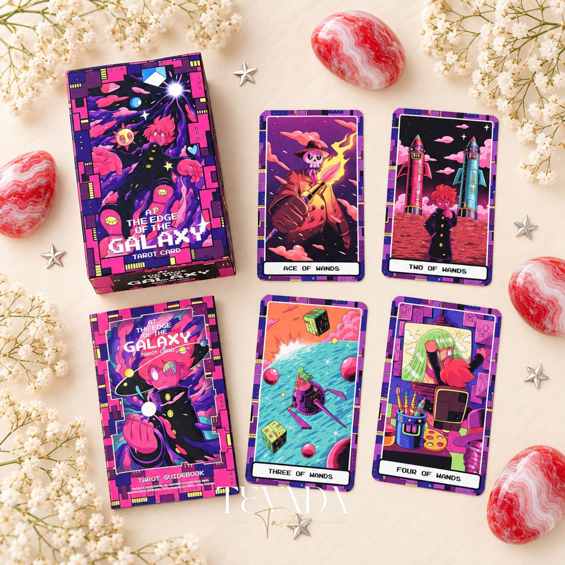 At the Edge of the Galaxy Tarot box and guidebook beside neon illustrated tarot card fronts on a pale floral background.