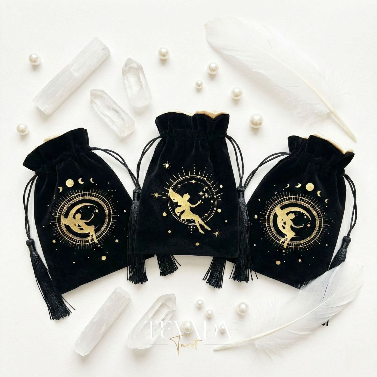 Black velvet tarot pouch with gold stamping and tassels for protecting tarot decks and crystals on a witchy altar.
