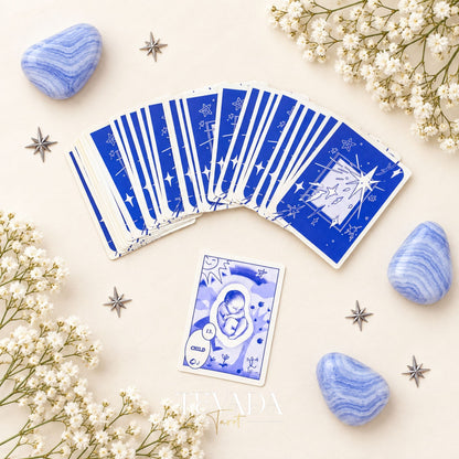 A spread of Klein-blue Lenormand cards, including a star-pattern card back and a bear card, styled with agate and white blossoms.