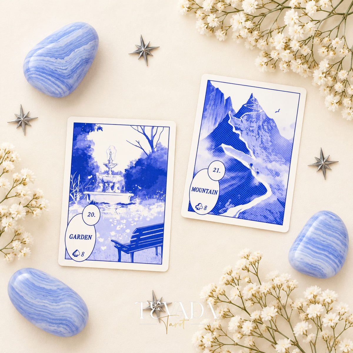 The Heart and Ring Lenormand cards, numbered 24 and 25, displayed with blue stones and white blossoms.