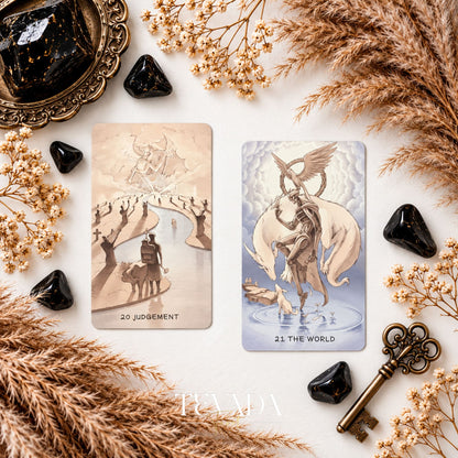 Ethereal Poetry Tarot Deluxe Judgement and The World cards shown together among dried grasses and black crystals.