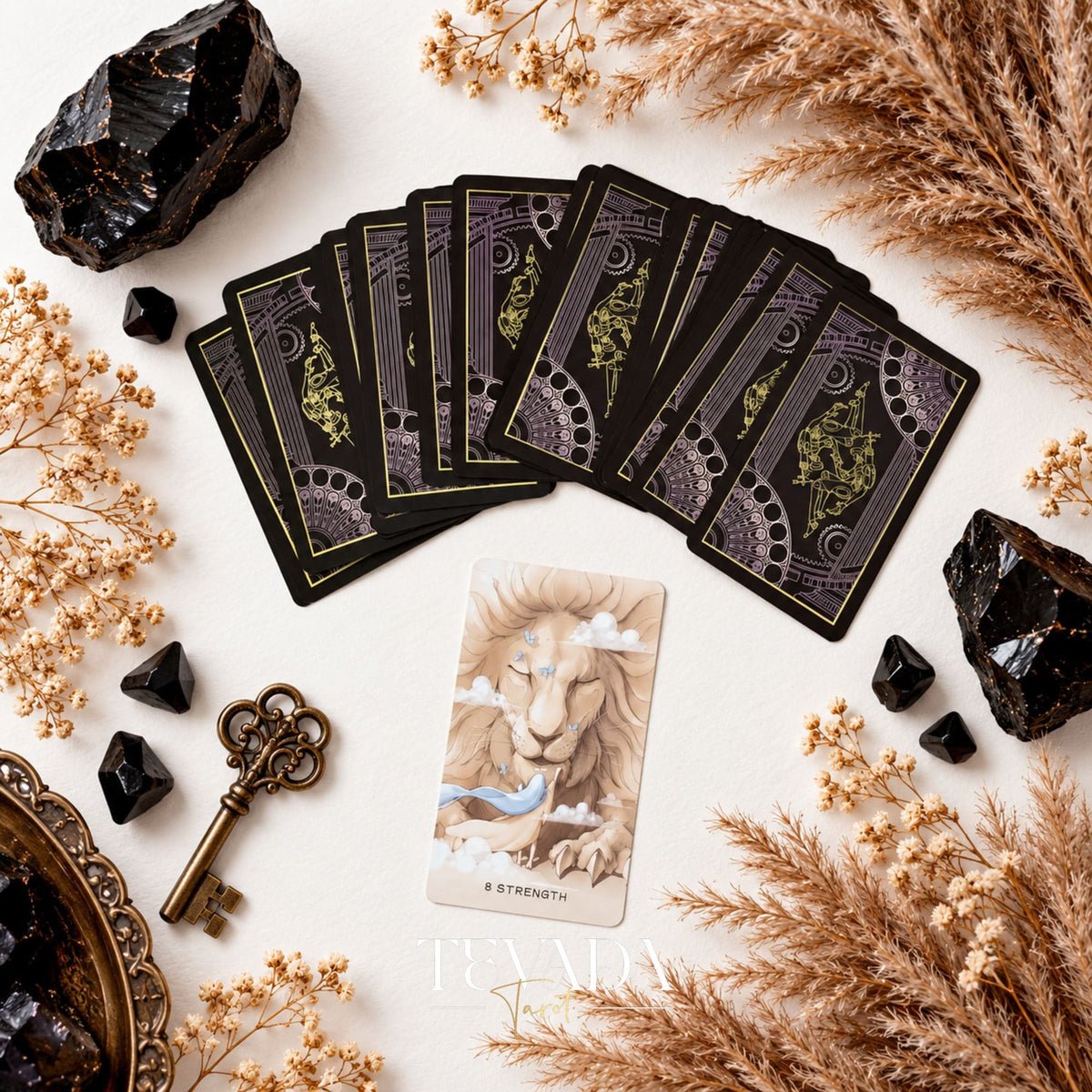 Ethereal Poetry Tarot Deluxe dark ornamental card backs fanned above a sepia illustrated tarot card.