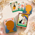 Heard Oracle deck and sliding box with bilingual storybook cards, including a girl with a black cat.