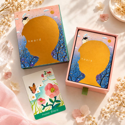 Heard Oracle gold-stamped sliding box beside a pastel flower and butterfly card.
