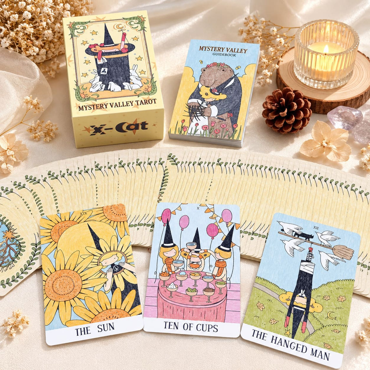 Mystery Valley Tarot DELUXE tarot card artwork with playful witches, storybook forests, and oversized fantasy creatures