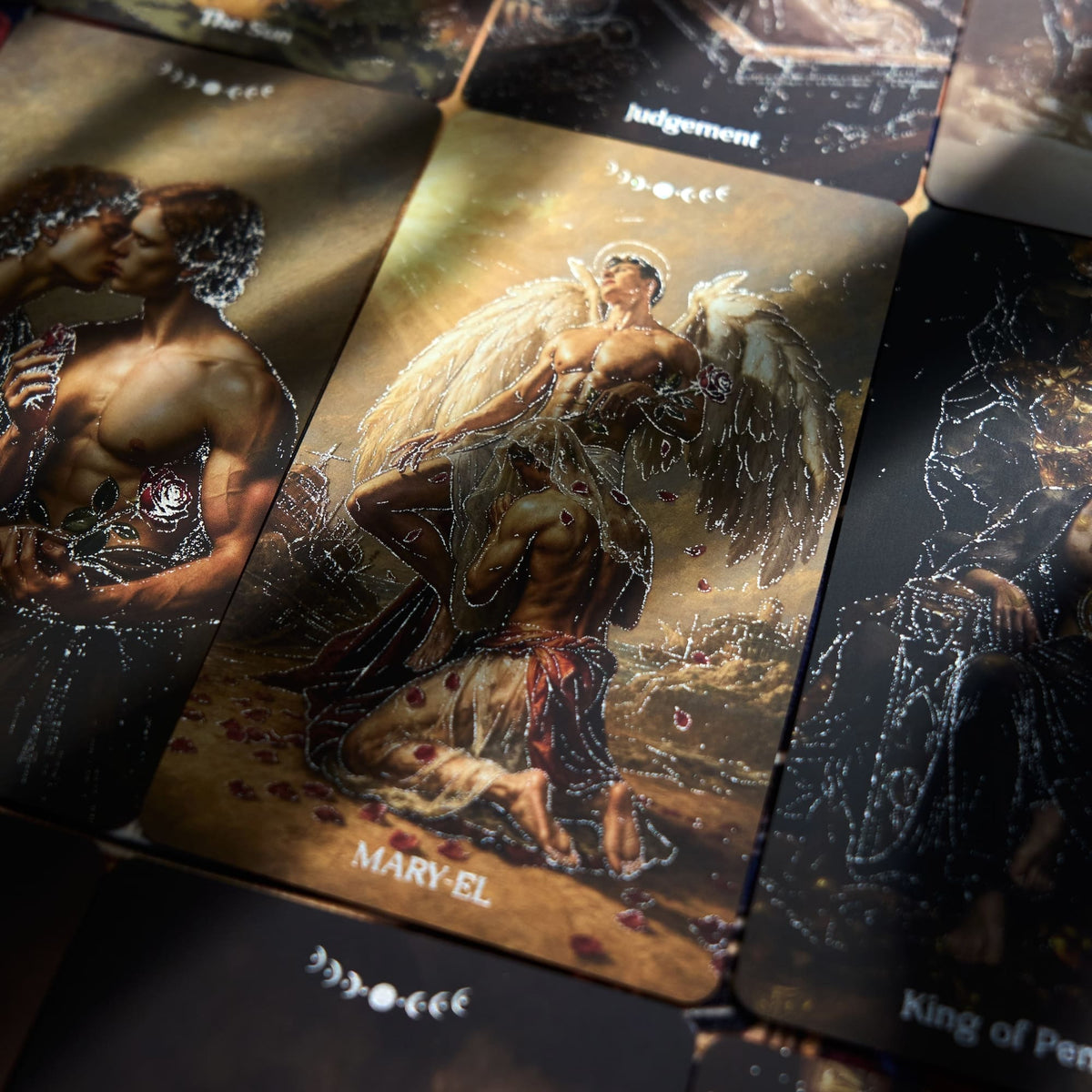 Pact of the Arcana Tarot rigid box and red gilded deck displayed with dark romantic card artwork