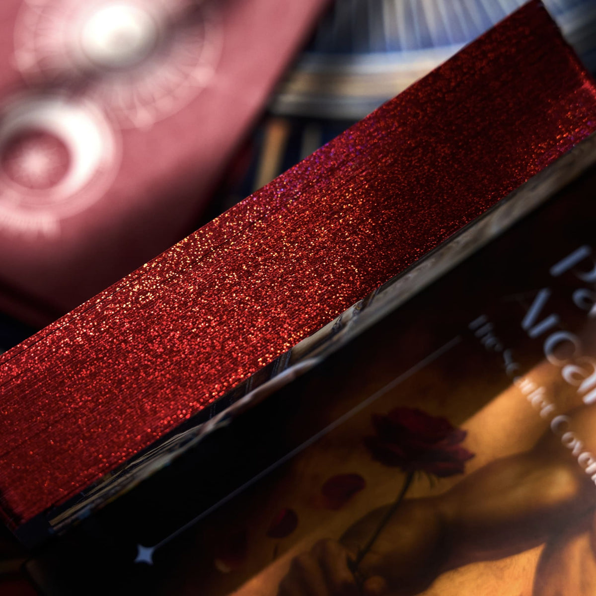 Close-up of Pact of the Arcana Tarot box and stacked cards highlighting dark romantic artwork and metallic foil