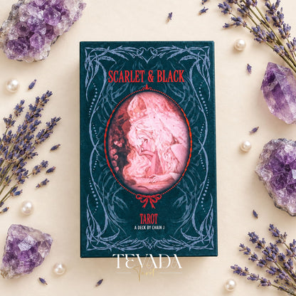 Scarlet &amp; Black Tarot box and gothic illustrated cards arranged on a cream surface with purple amethyst crystals, pearls and lavender sprigs.