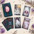 A selection of Scarlet & Black Tarot cards with dramatic red, black and white gothic illustrations, displayed beside the deck box.