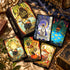 Tales of Catrealm Tarot DELUXE Edition box, card backs and face-up illustrated cat cards on dark fabric.