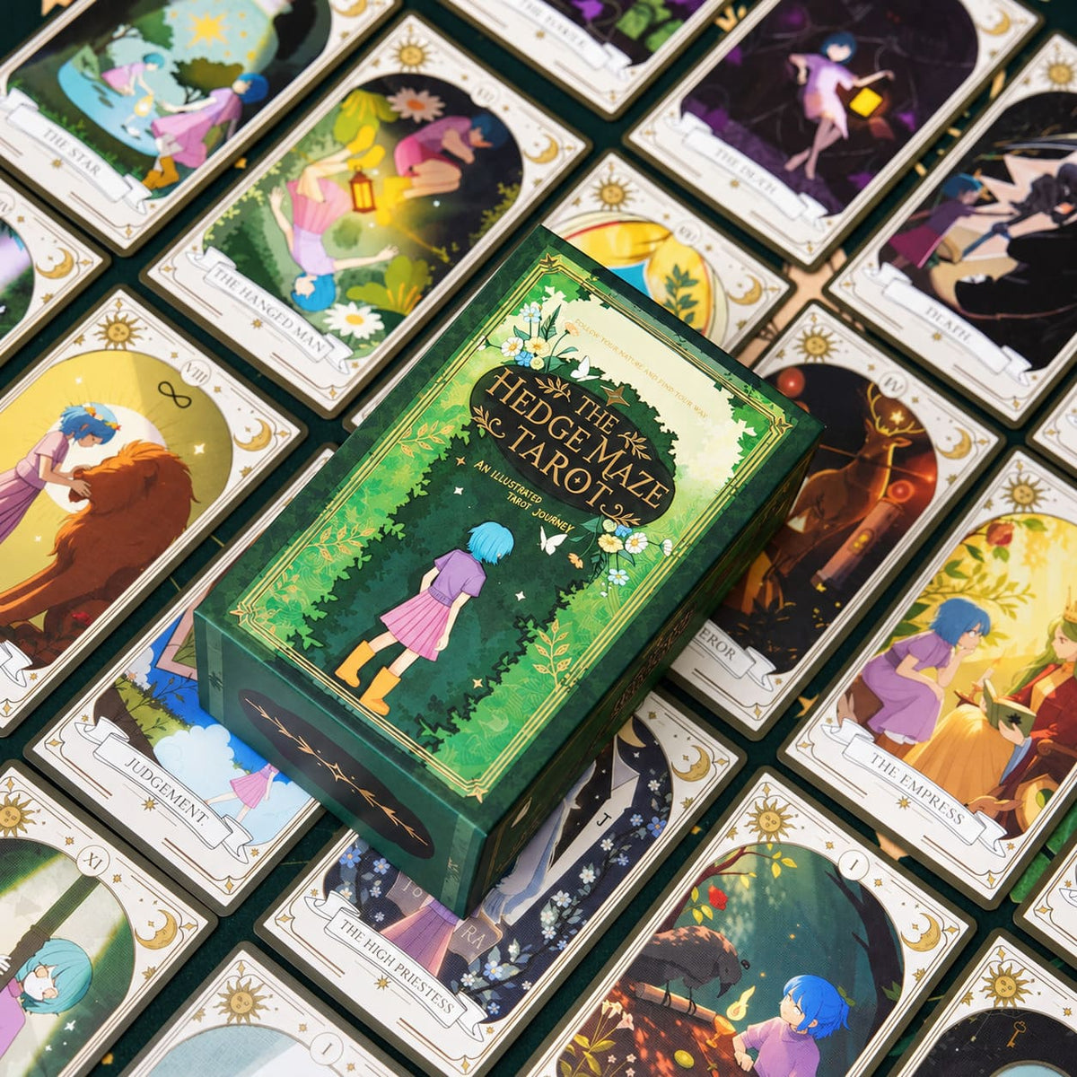 The Hedge Maze Tarot box resting on a spread of colorful storybook cards with white decorative borders.