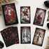 The Lost Land Tarot Fading Edition deck box and dark watercolor tarot cards arranged with black crystals and a vintage key