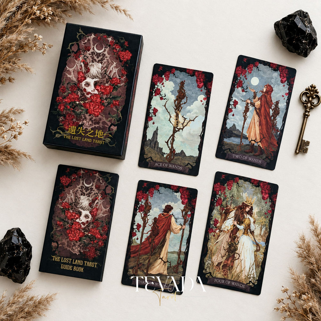 The Lost Land Tarot Fading Edition red-edged deck box with Ace of Wands, Two of Wands, and other dark watercolor tarot cards
