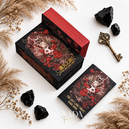 Open The Lost Land Tarot Fading Edition box showing the red-edged deck beside the illustrated box lid