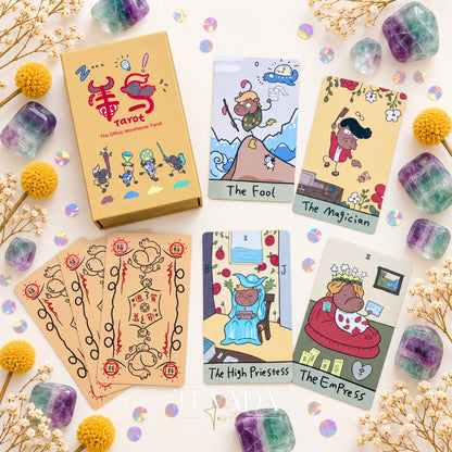 The Office Workhorse Tarot box surrounded by funny cow tarot cards, colorful crystals, and dried flowers on a pastel background.